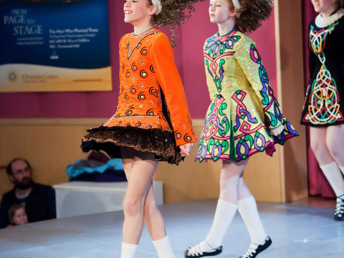 Irish stepdancers performing in traditional dance costume